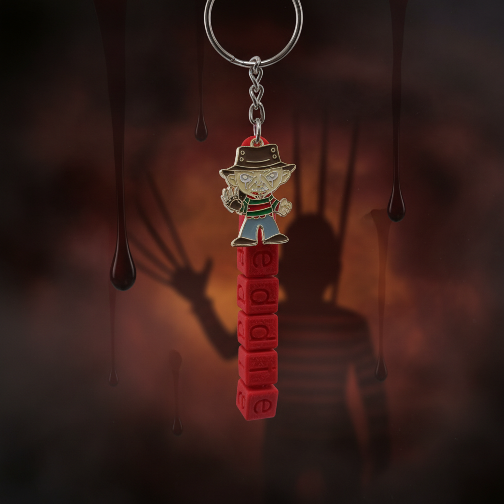 Freddy Krueger themed 3D printed keychain with red letter blocks on dark moody background