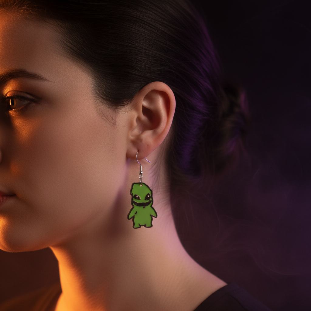 Chibi green monster earrings worn on ear with dark moody Halloween background