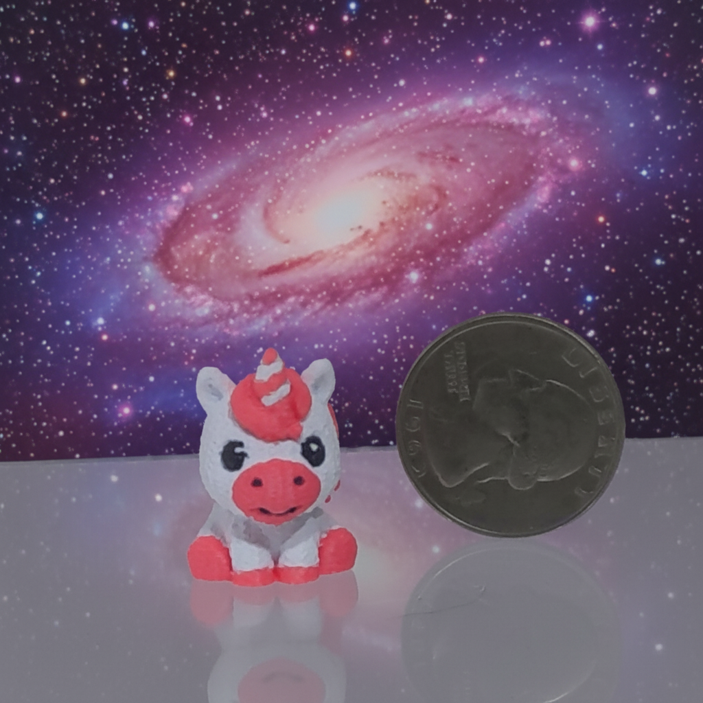 Tiny Hooves micro 3D printed unicorn next to a quarter on galaxy background, no tweezers