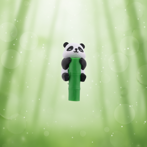 Close-up of panda straw topper on green bamboo background