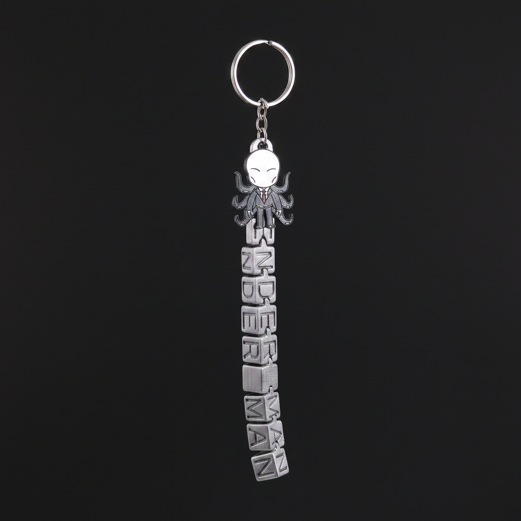 Chibi Slender Man keychain with SLENDER MAN silver text tag on dark charcoal background